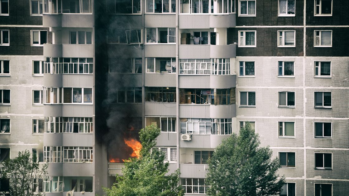 Fire and smoke billowing from apartment balcony
