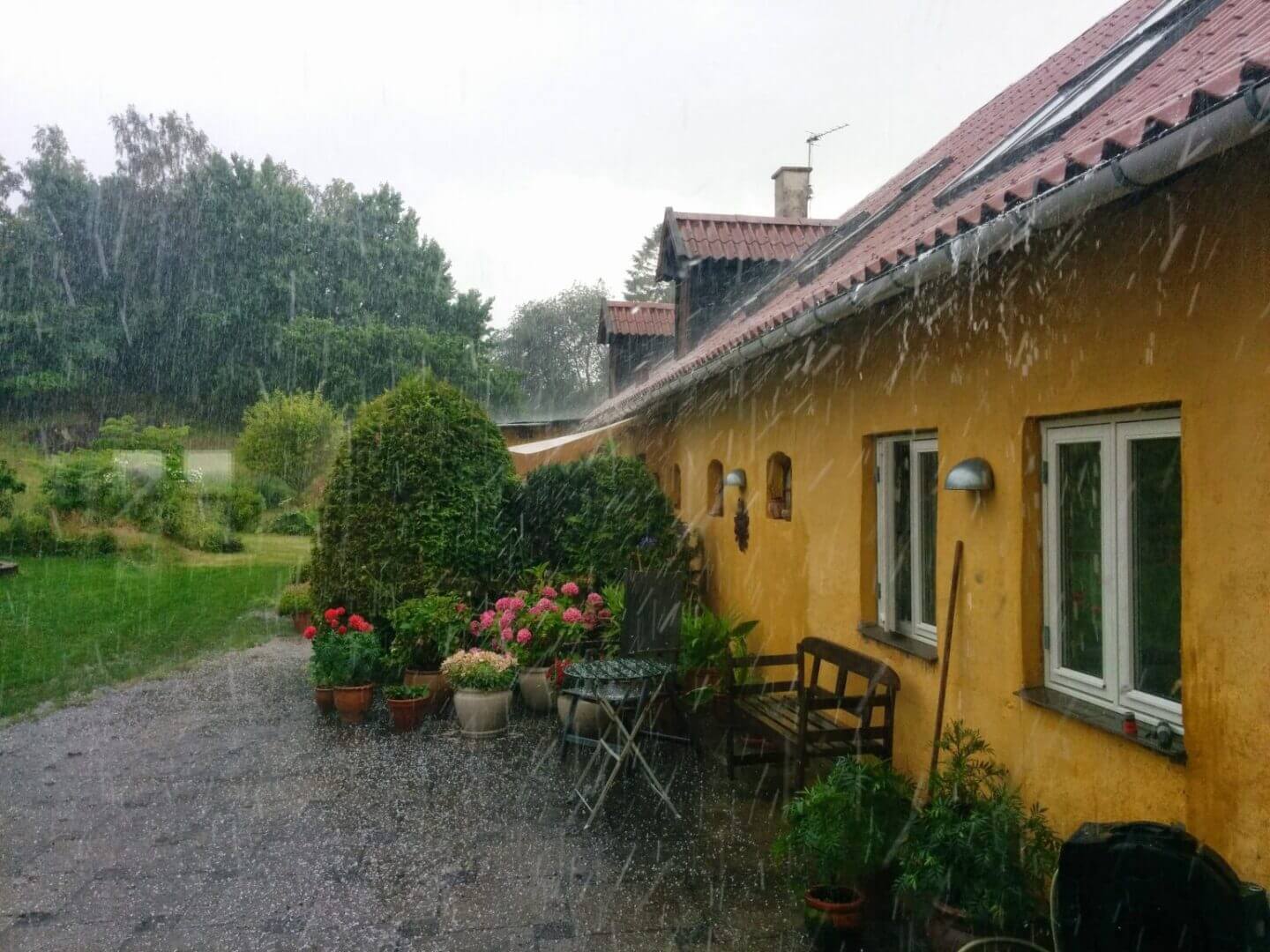 Yellow house courtyard in heavy rain